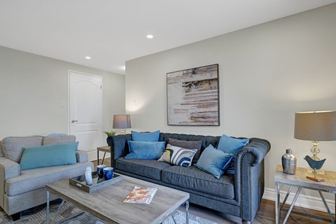 A living room with a grey couch and a coffee table.