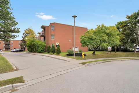A street view of a residential area with apartment buildings.
