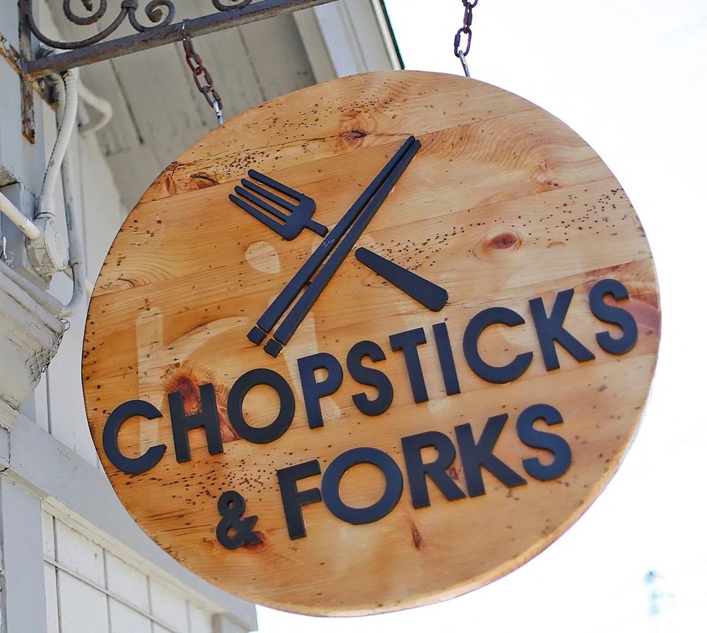 a wooden sign that reads chopsticks and forks
