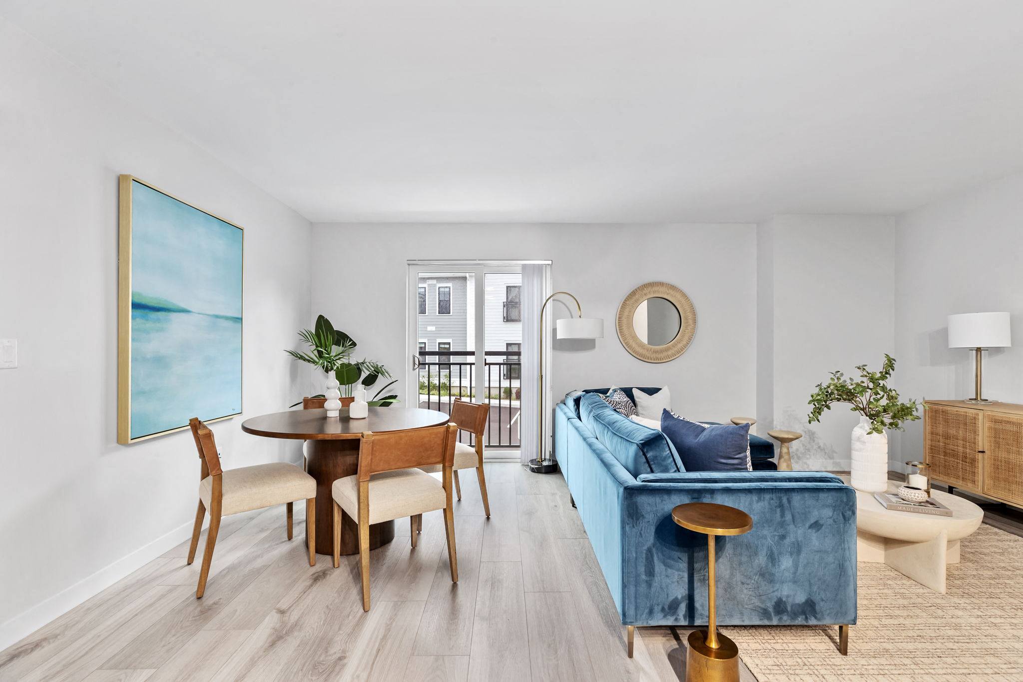 a dining and living room with a blue couch