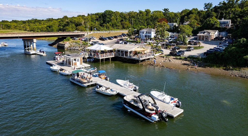 a group of boats docked in the water at a marina