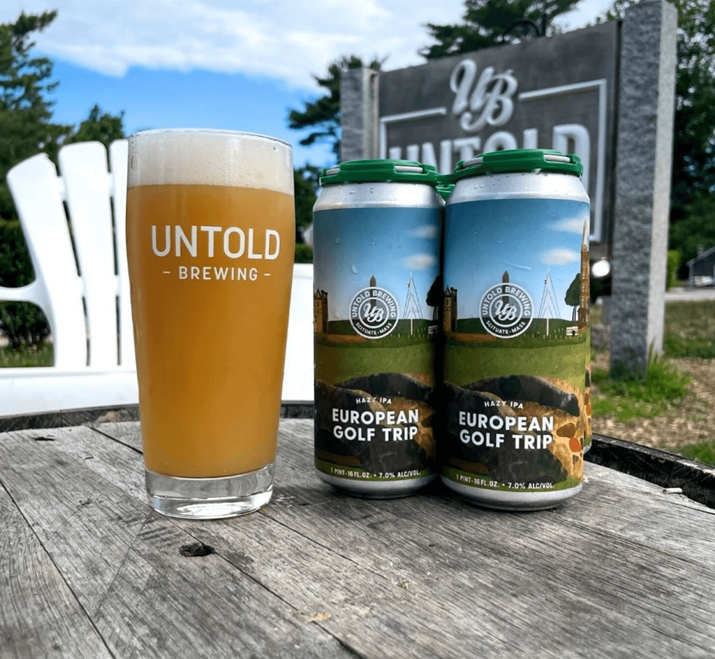 two cans of union brewing and a glass of beer on a table