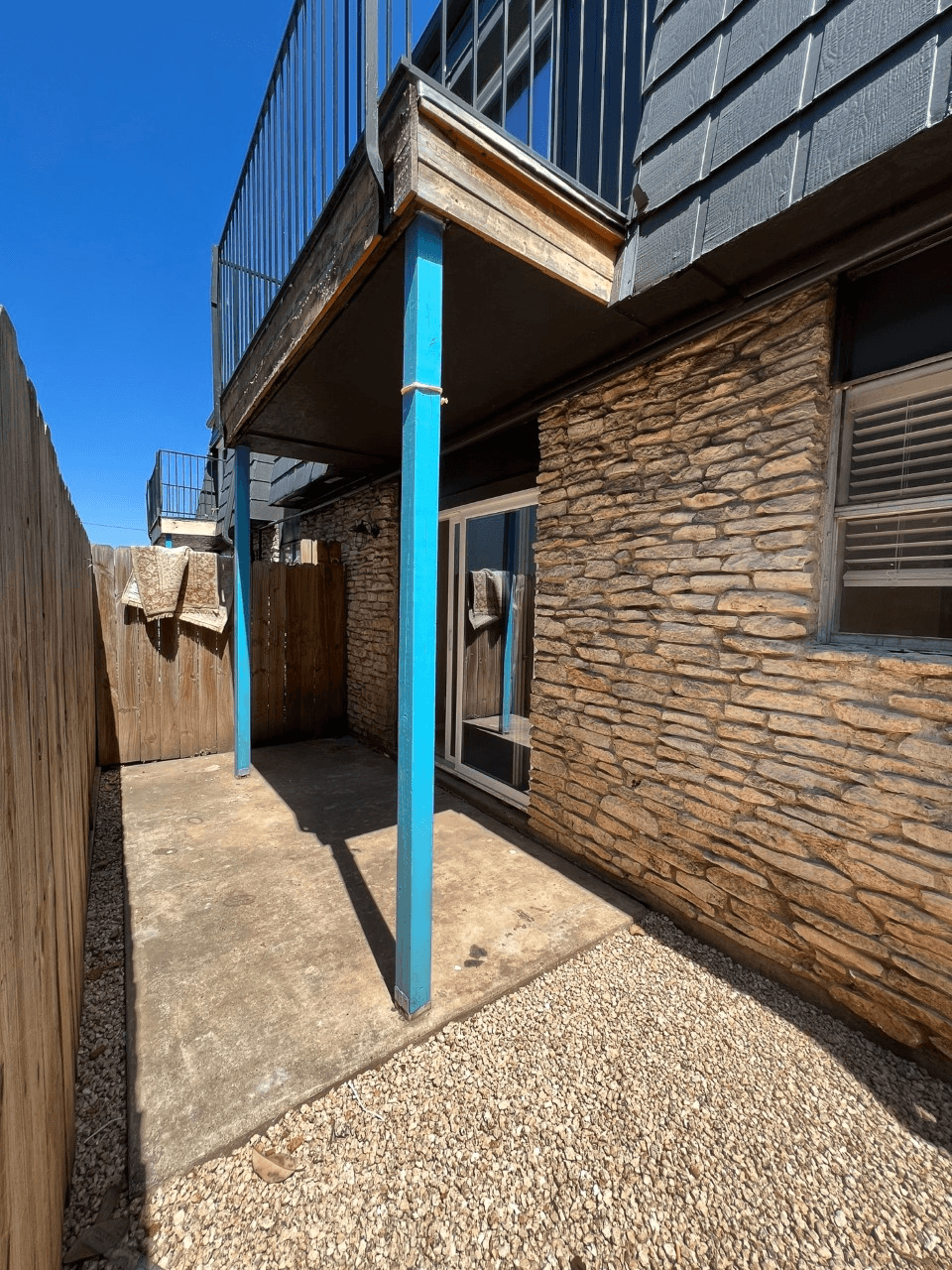 a blue pole in front of a brick building