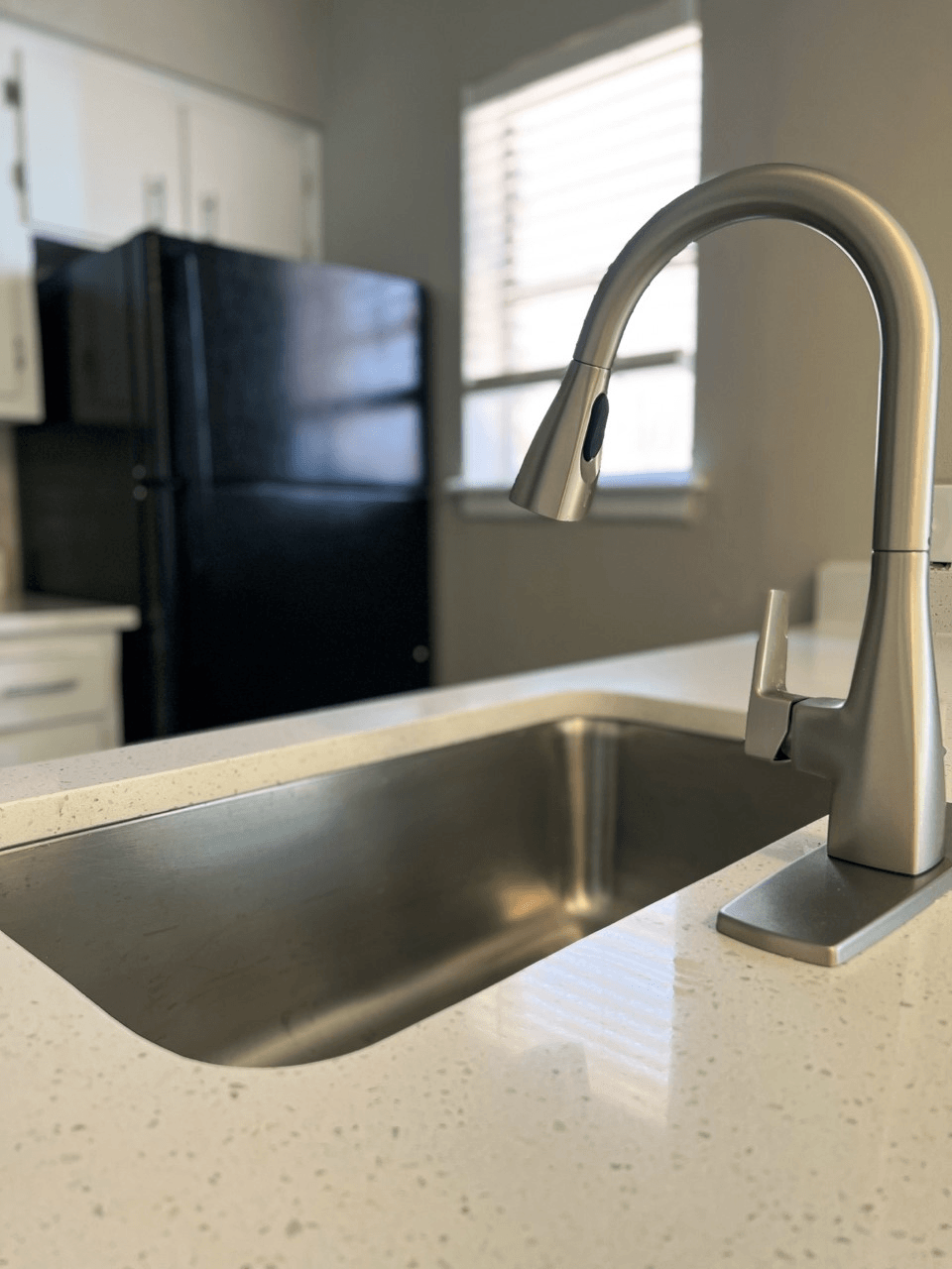 a kitchen sink with a chrome faucet