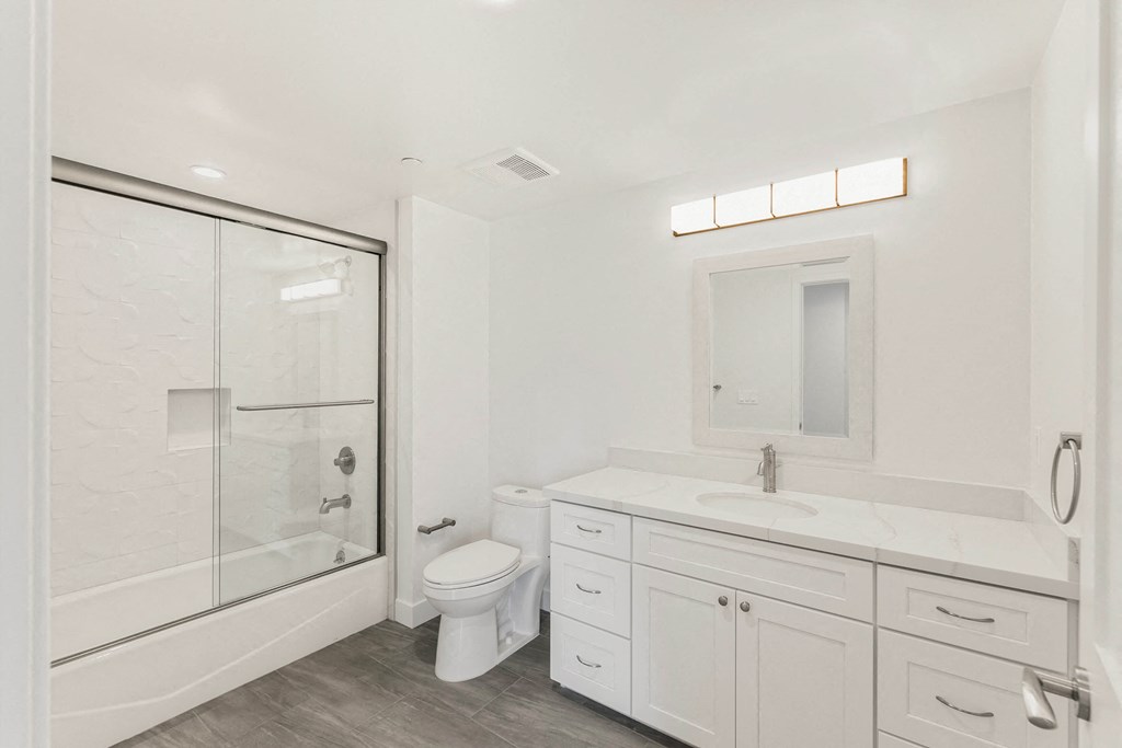 a bathroom with a toilet sink and shower