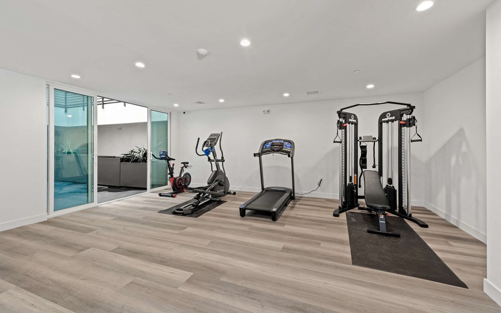 a gym with treadmills and other exercise equipment