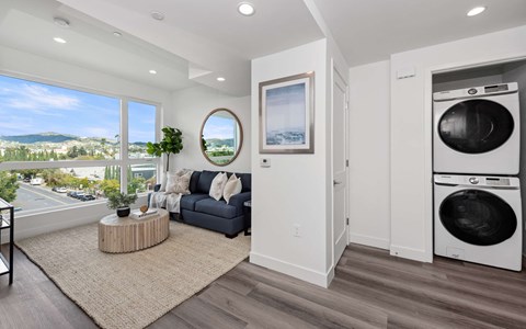 a living room with a couch and a washing machine