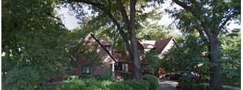 a house surrounded by trees and bushes