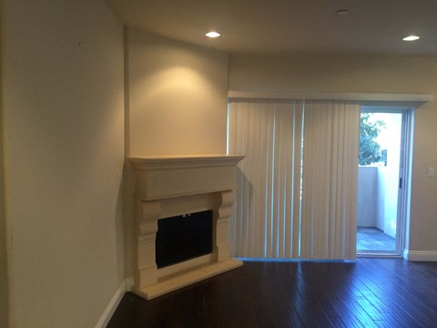 a living room with a fireplace and a sliding glass door