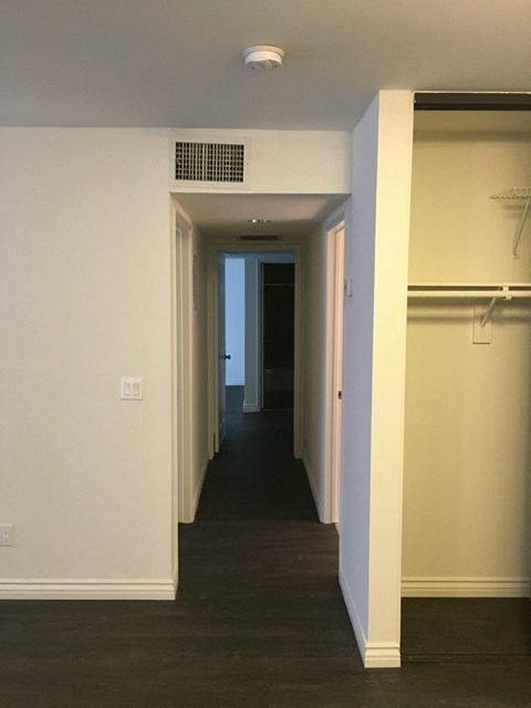 a look down the hall from the living room to the bedroom