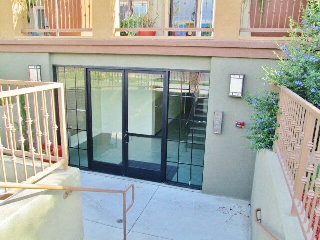 a building with a staircase and a glass door