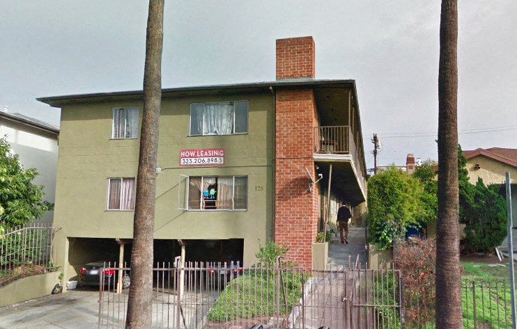 a house with a red and white sign on the side of it
