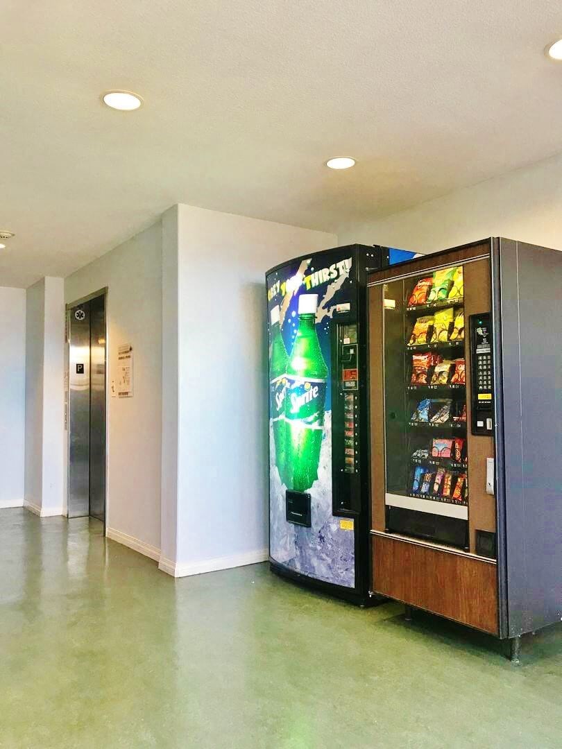 a vending machine with a bottle of beer on it