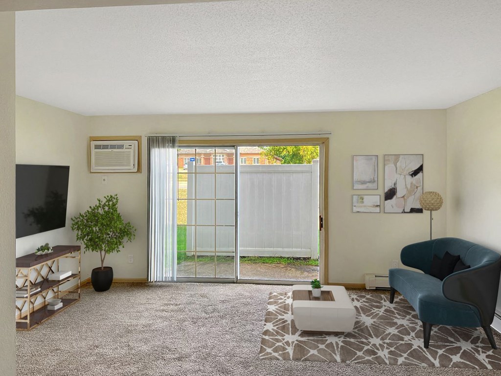 a living room with a sliding glass door leading to a backyard