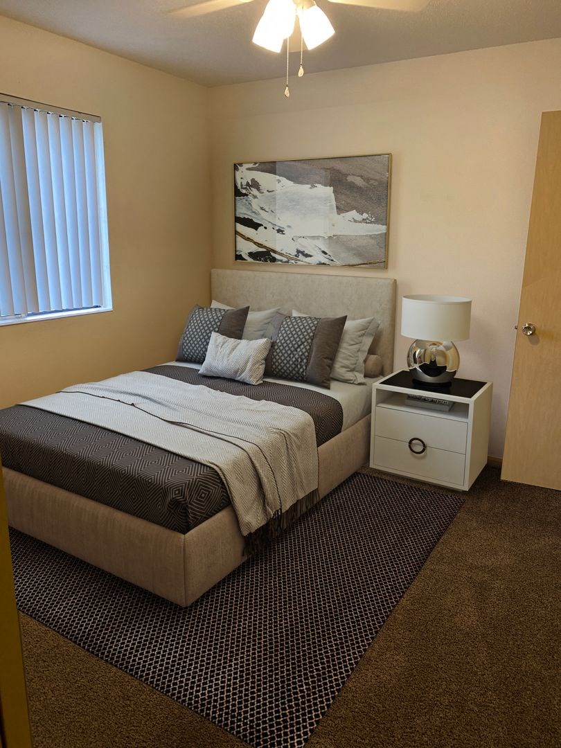 a bedroom with a bed and a nightstand