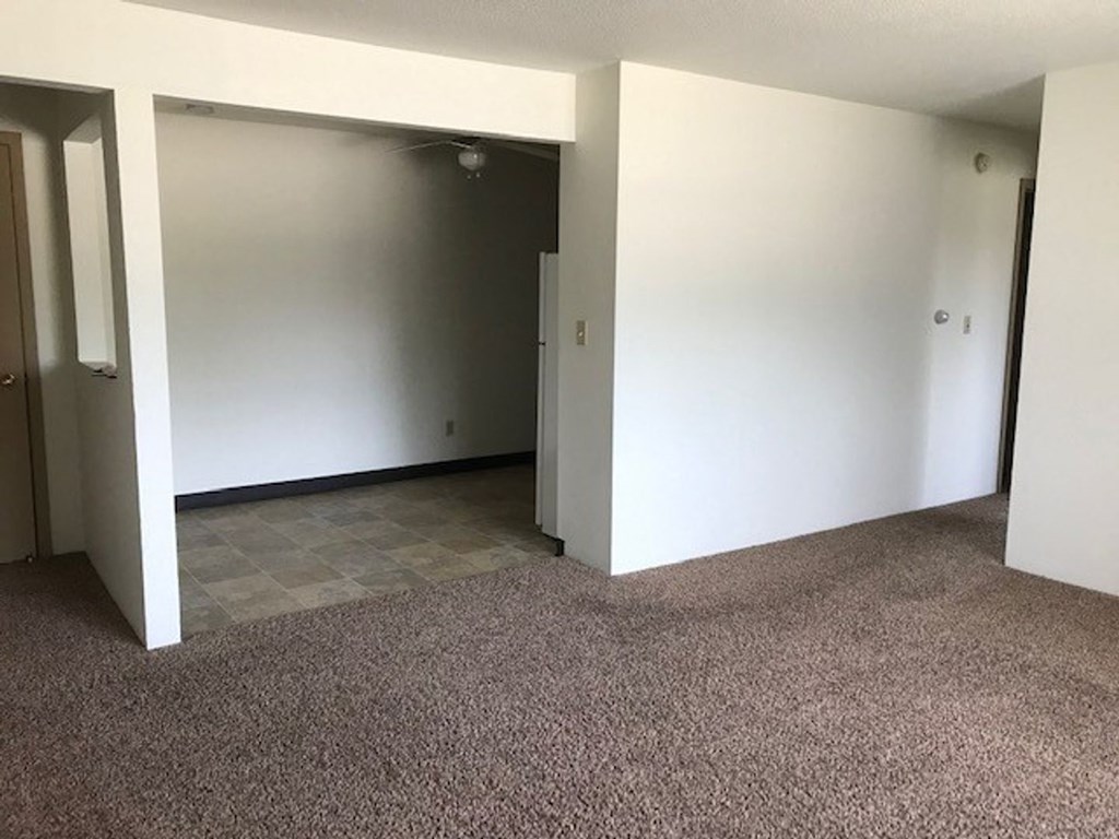 an empty room with a door that is open