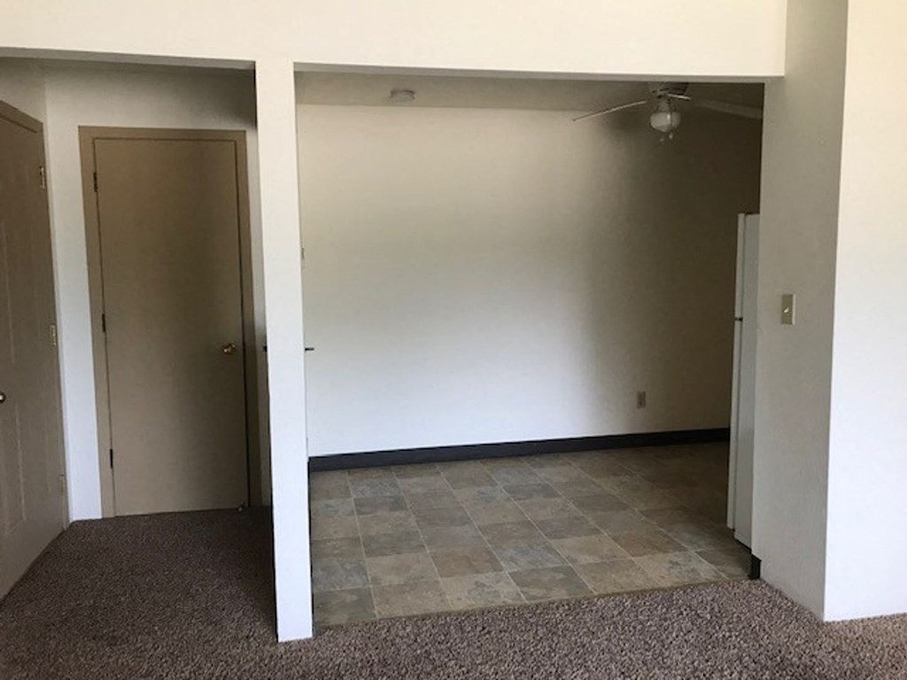 an empty room in a house with a tiled floor