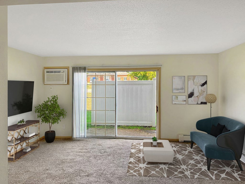 a living room with a sliding glass door leading to a backyard