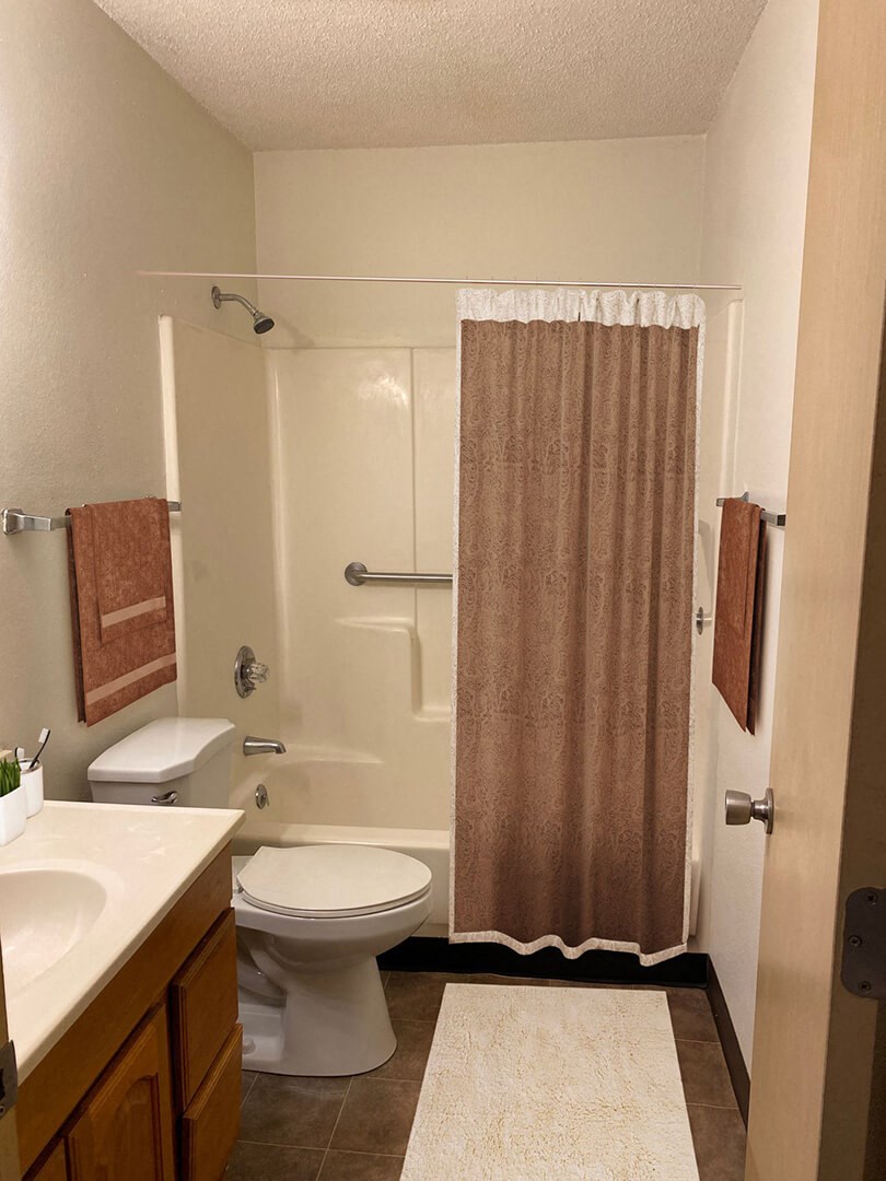 a bathroom with a toilet sink and shower