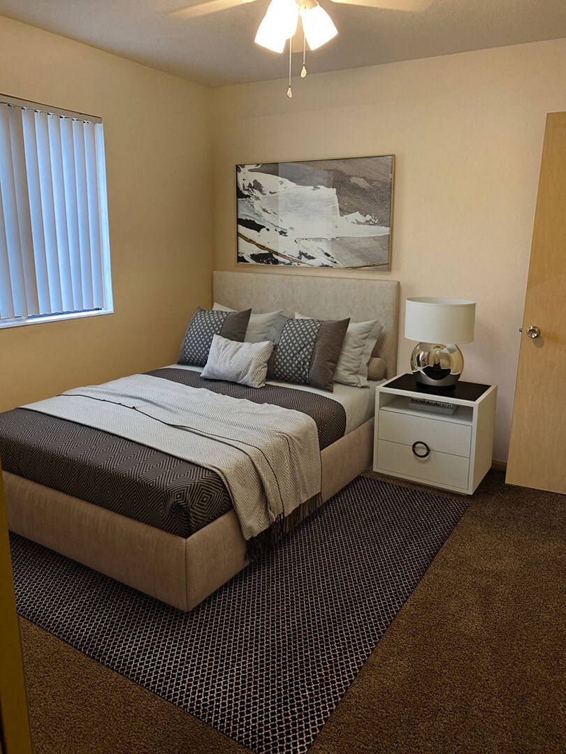 a bedroom with a bed and a nightstand