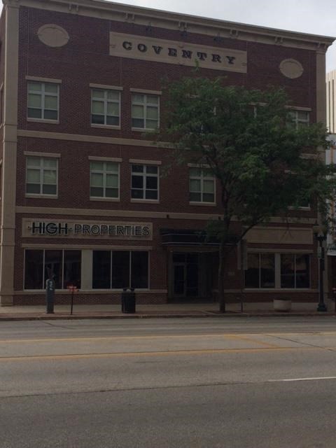 a large brick building with a sign that reads high profits