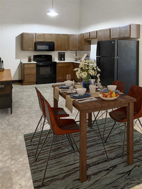 a kitchen with a table and chairs and a refrigerator