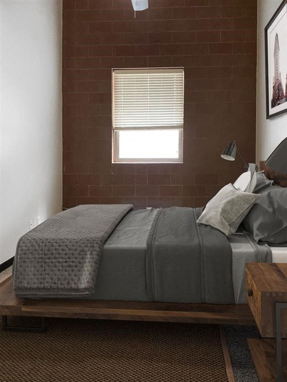 a bedroom with a bed and a window