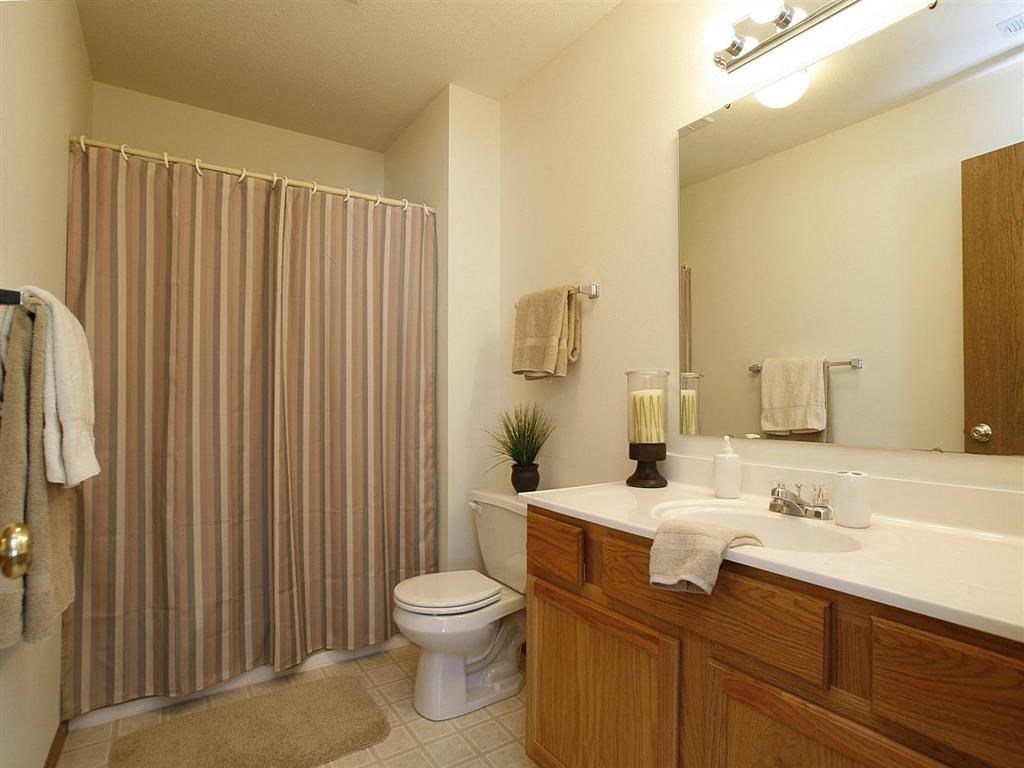 a bathroom with a toilet sink and shower