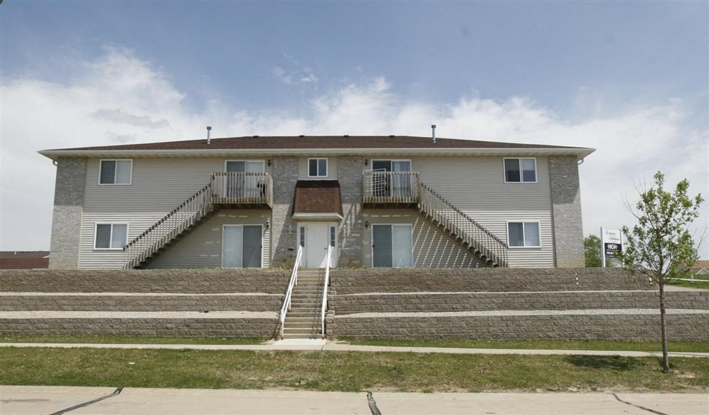 a large white building with stairs in front of it