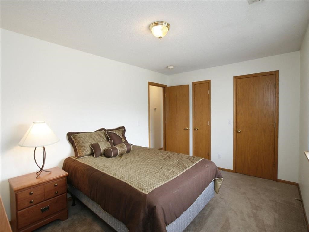 a bedroom with a bed and two doors