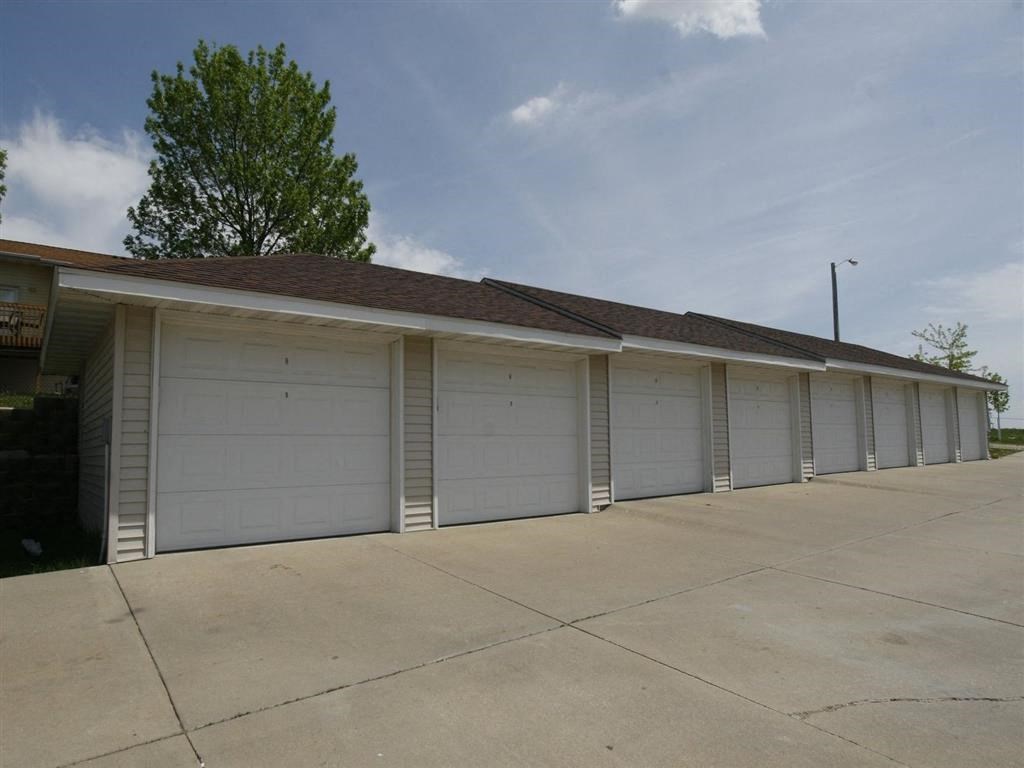 a row of garages with a blue sky in the background