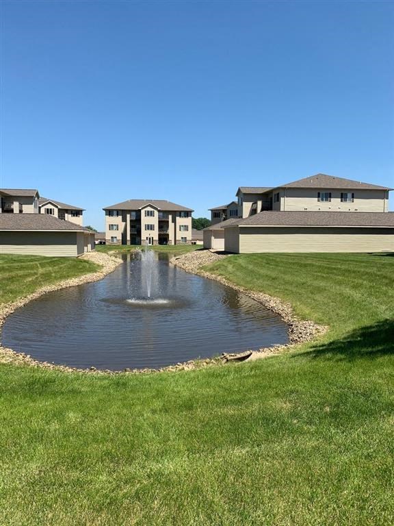 a fountain in the middle of a grassy field
