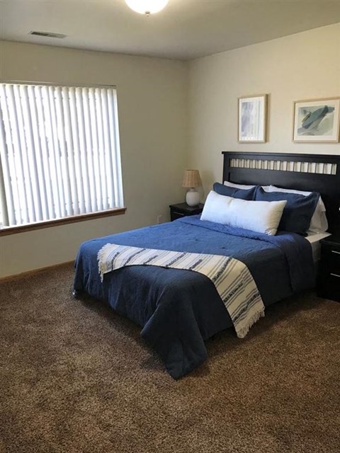 a bedroom with a bed and two night stands