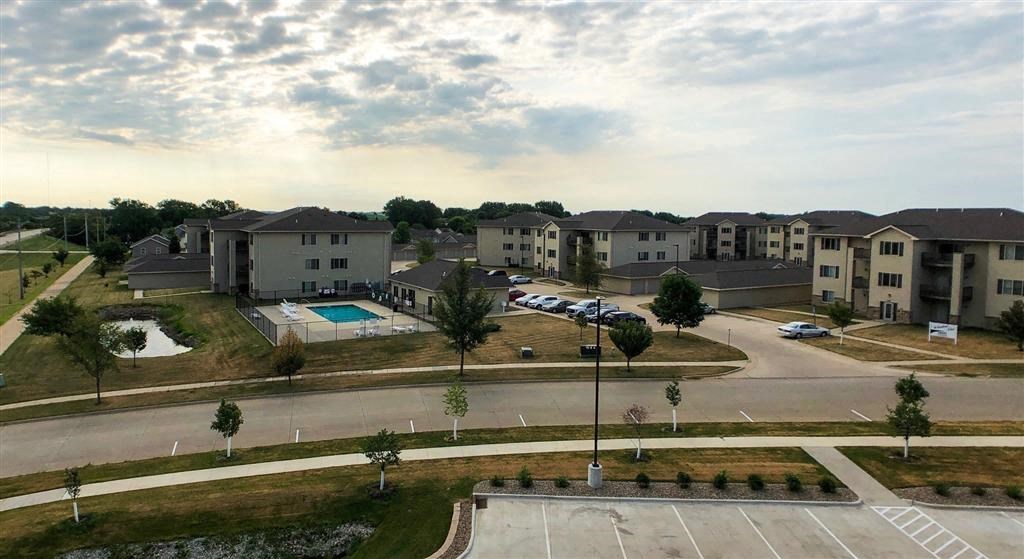 an aerial view of a subdivision with houses and a swimming pool