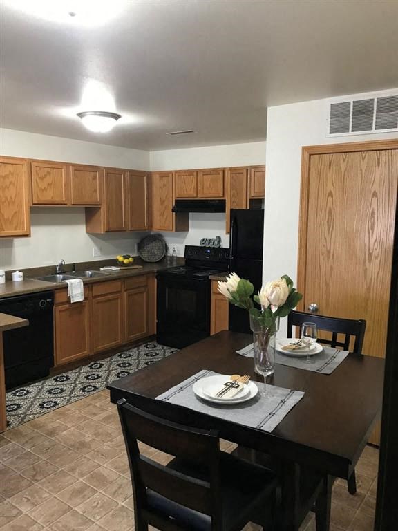 a kitchen and dining room with a table and chairs