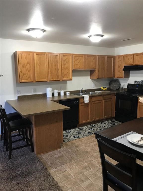 a kitchen with a table and chairs in it