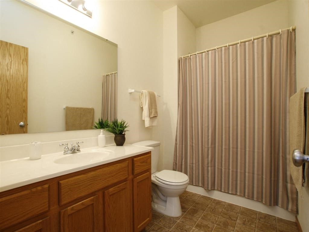 a bathroom with a toilet sink and shower