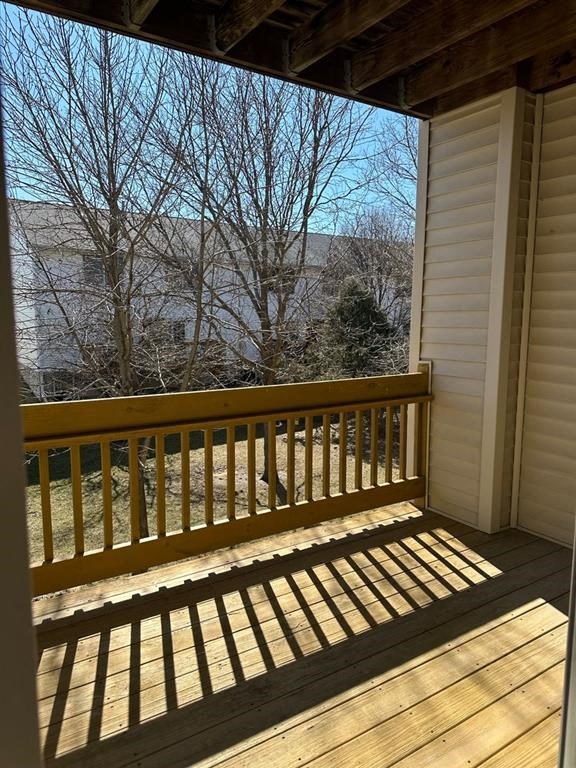 a wooden bench sitting on top of a wooden porch