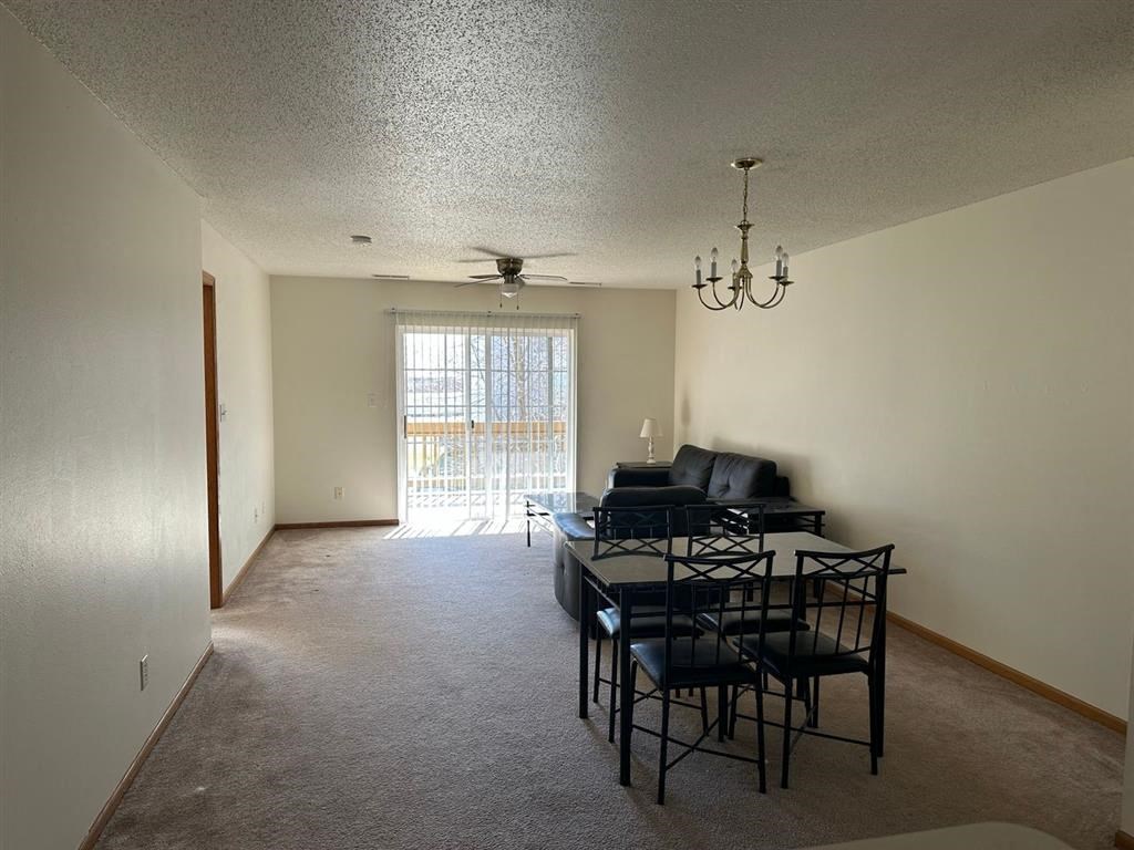 a dining room with a table and chairs and a chandelier