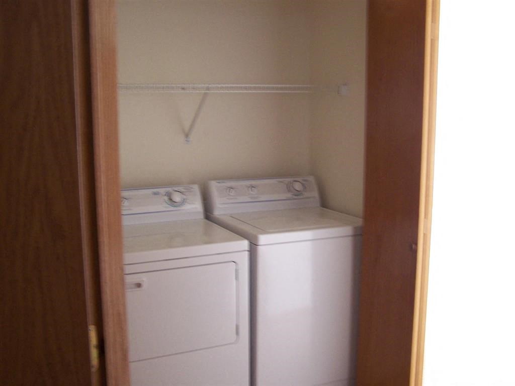 a white washer and dryer in a small room