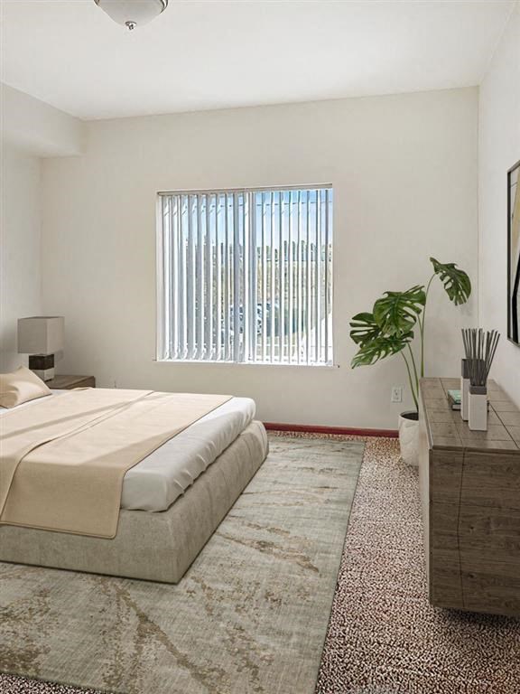 a bedroom with a large bed and a large window