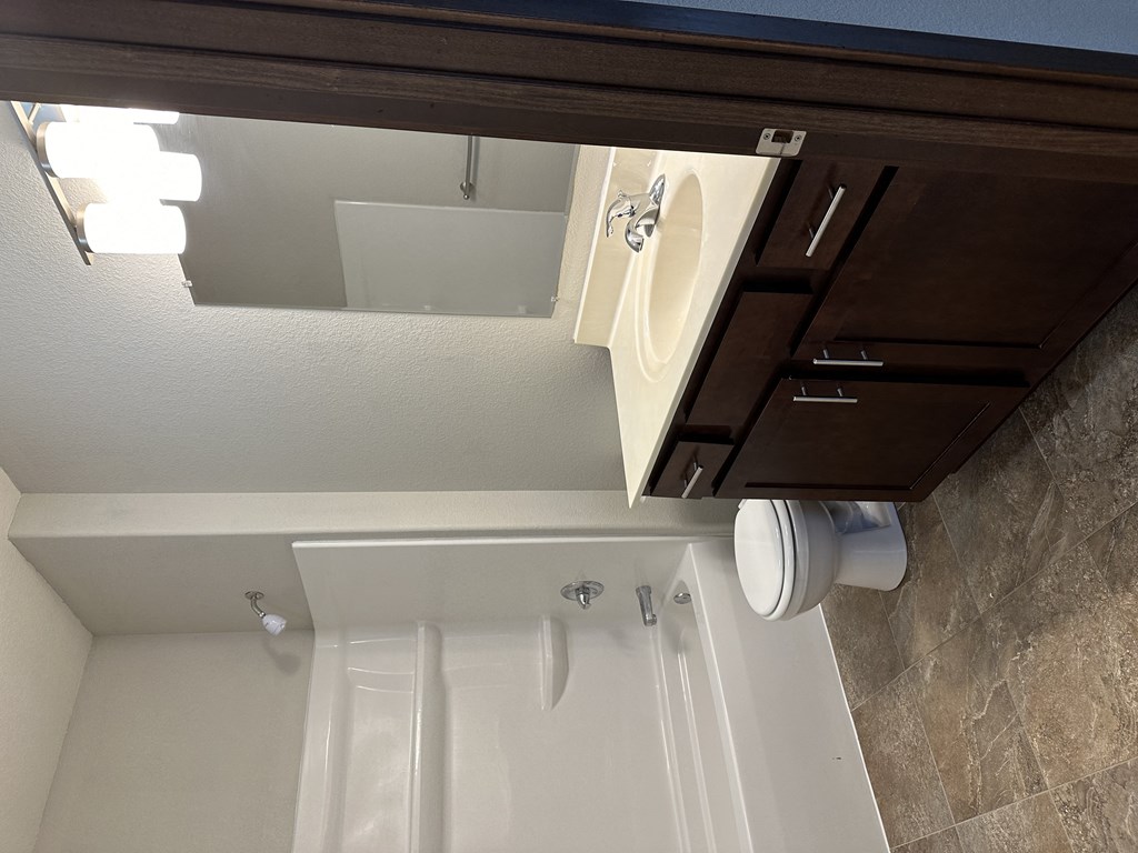 a bathroom with a toilet and a sink and a mirror