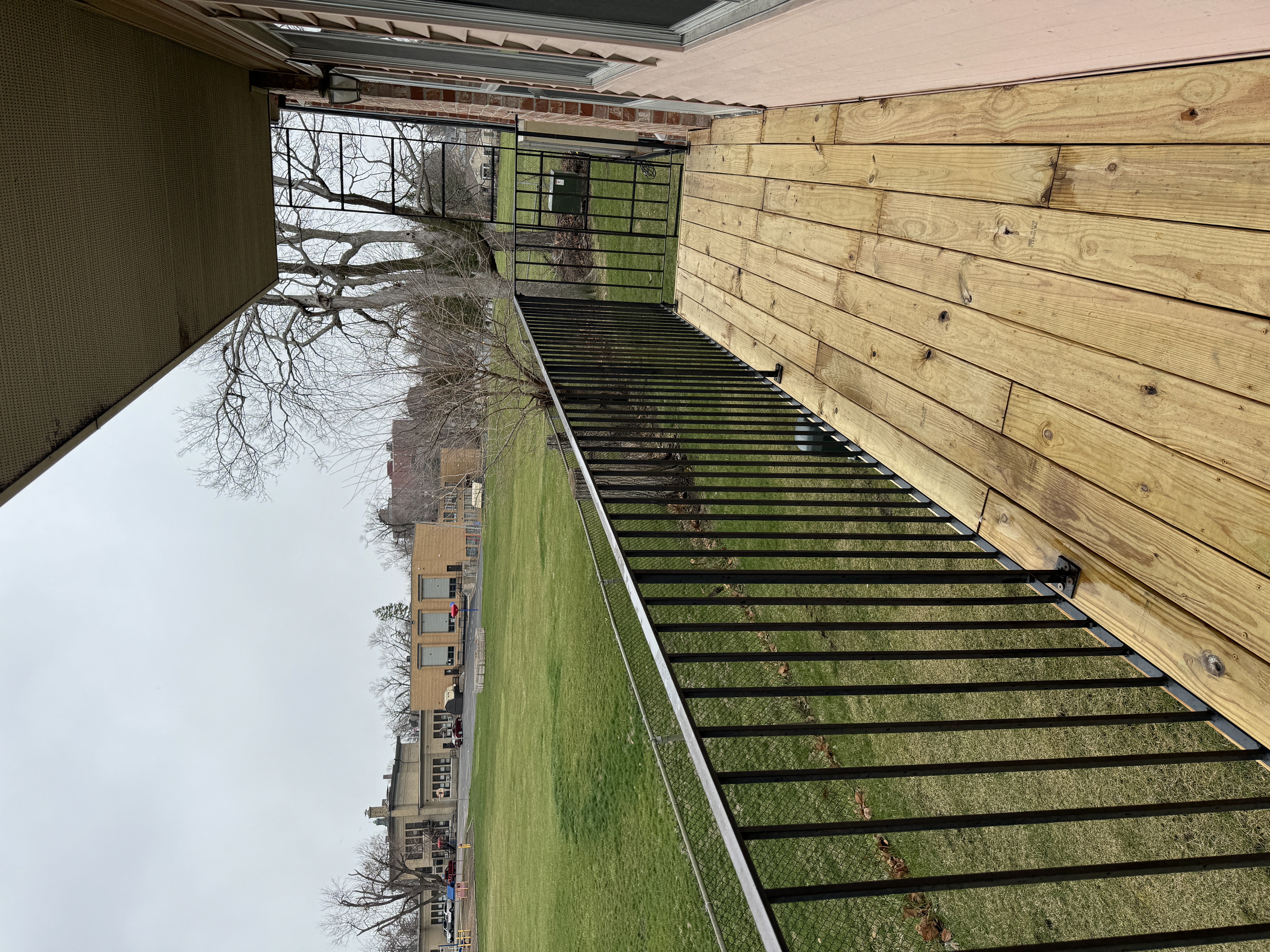 a view of the outside of a building with stairs and a wooden wall