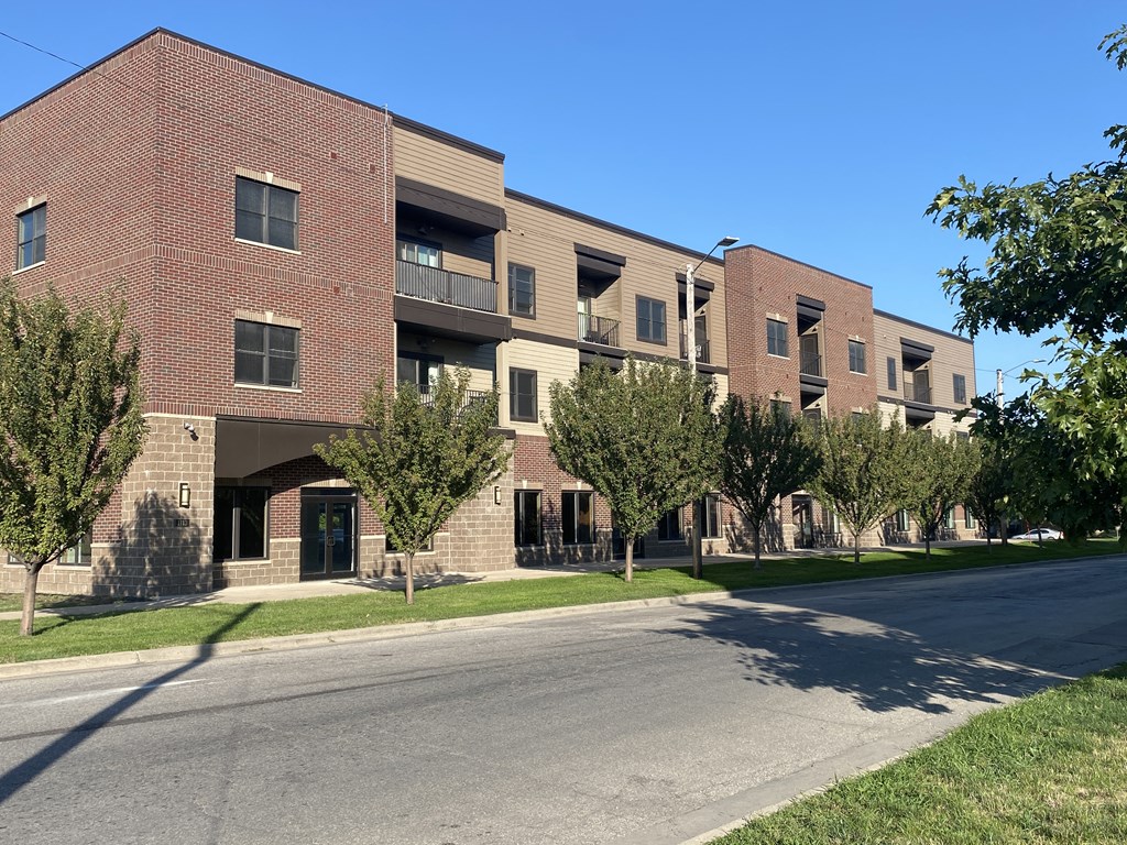 a large brick apartment building with a street in front of it