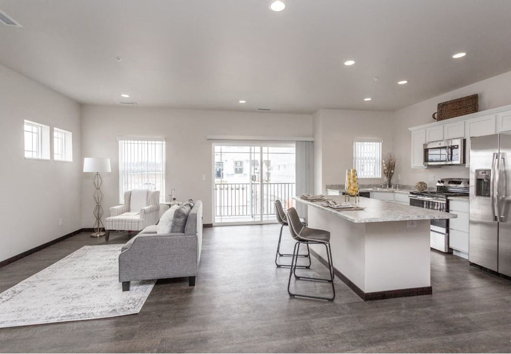 a kitchen and living room with an island and a white