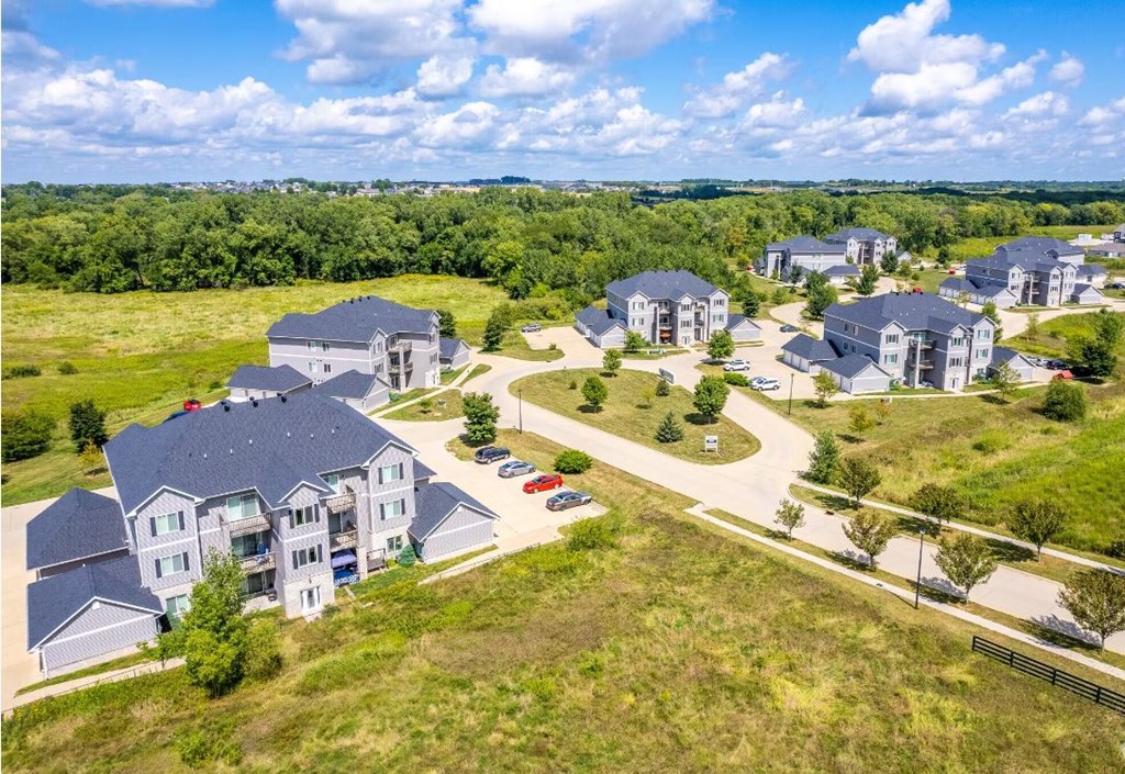 an aerial view of a group of houses in a field