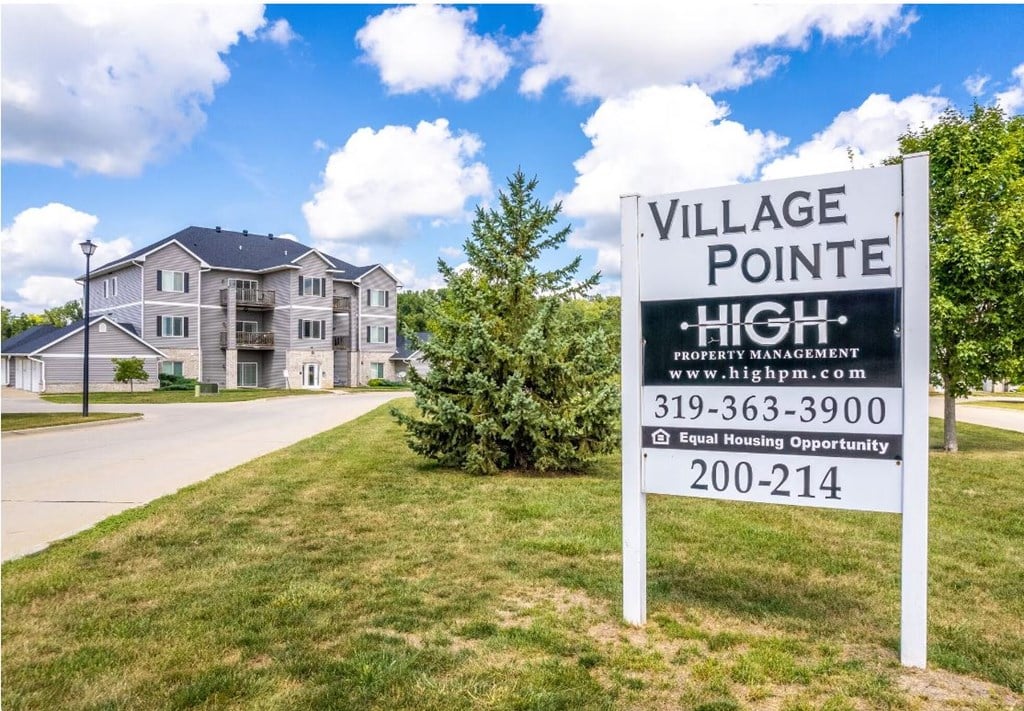 a village pointe high sign in front of an apartment building