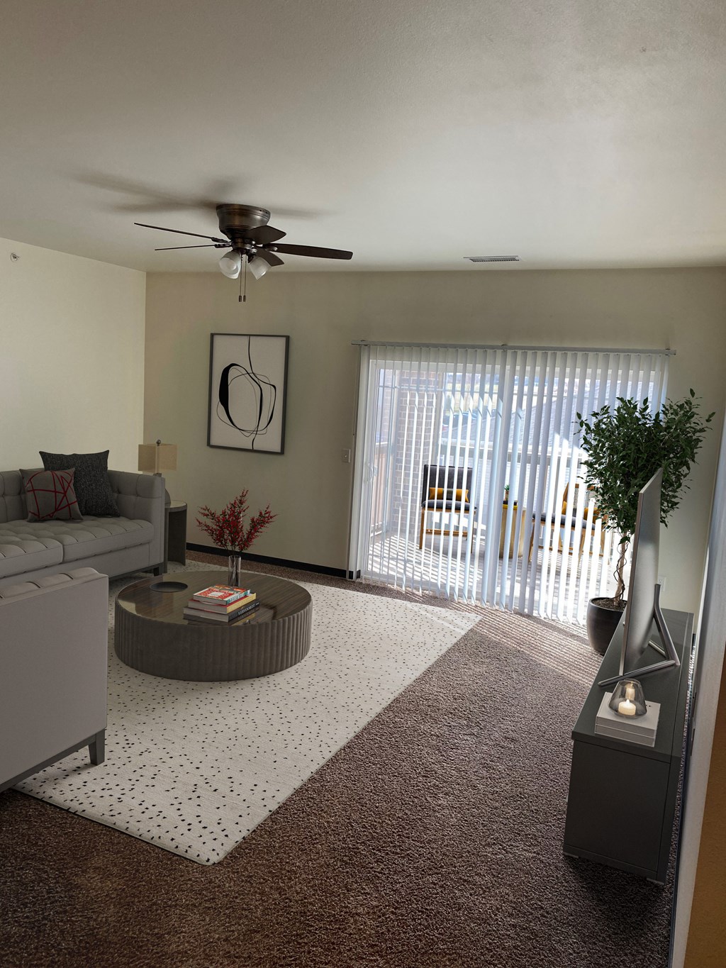 a living room with a couch and a table and a ceiling fan