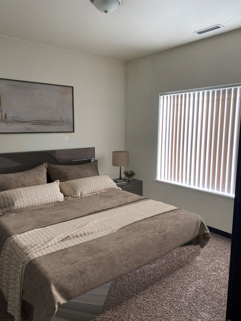 a bedroom with a bed and a window