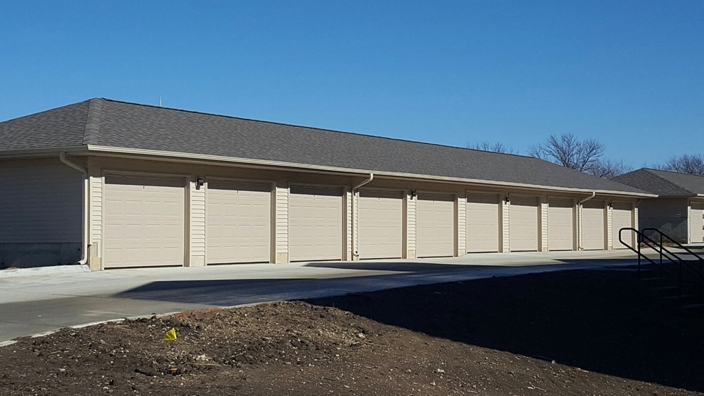 a row of garage doors in front of a building